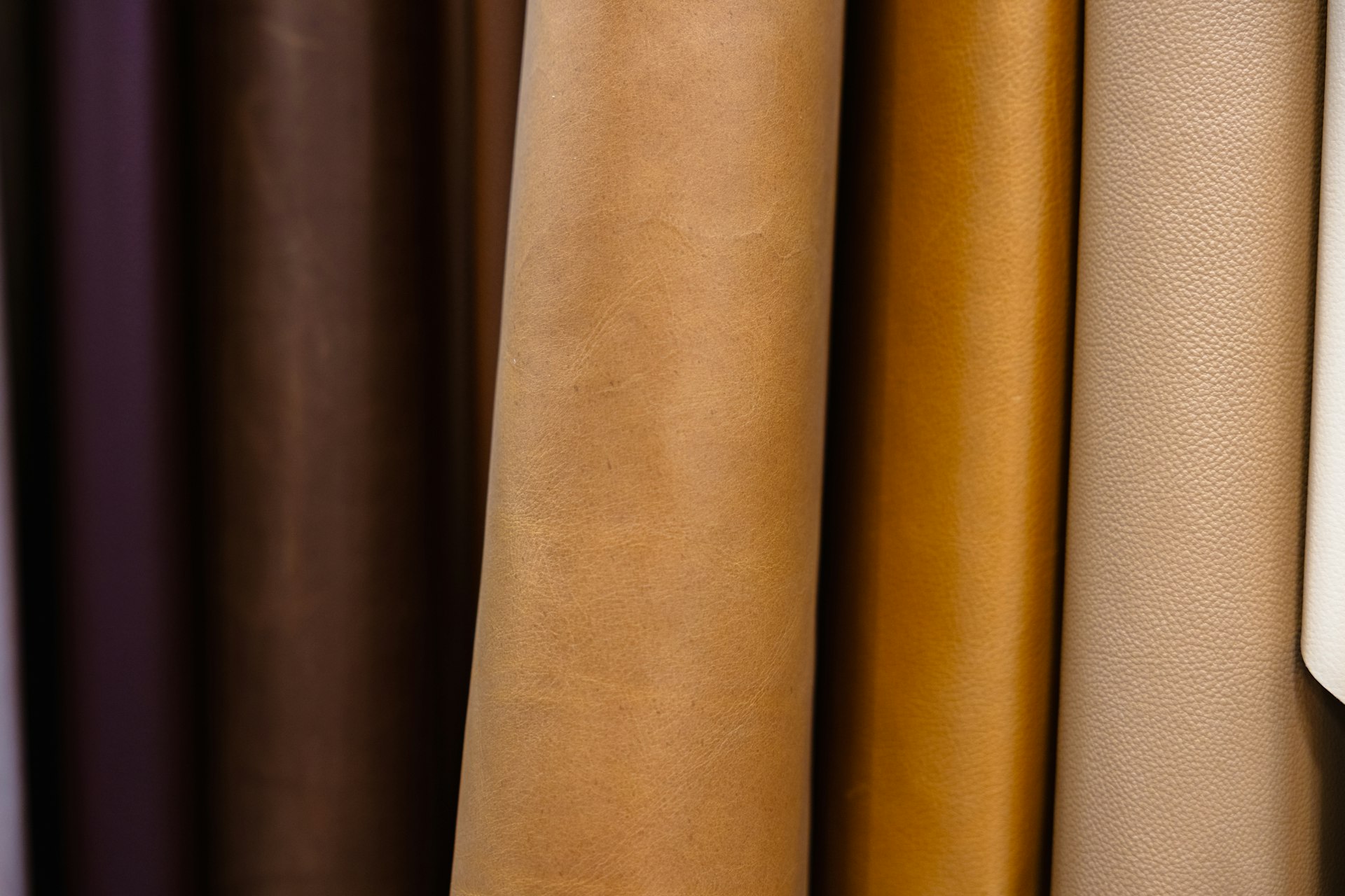 Various leather material samples placed side-by-side
